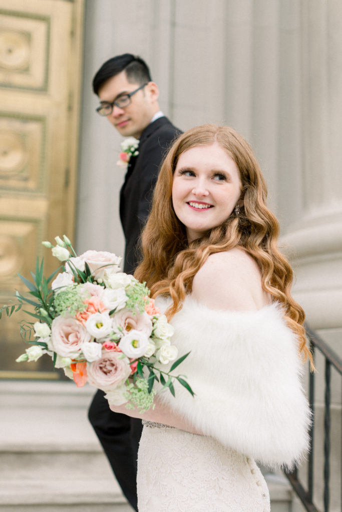 catholic-bride-and-groom-walking-up-steps-to-Indianapolis-Catholic-Church